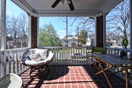 a rocking chair on a screened porch with a table at The Home Collection CLT: Kirkwood Avenue in Charlotte