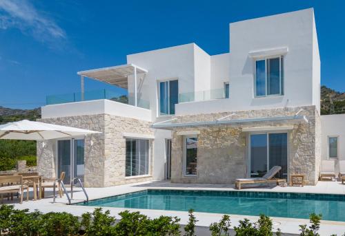 a villa with a swimming pool and a patio at serene villas in Ierápetra