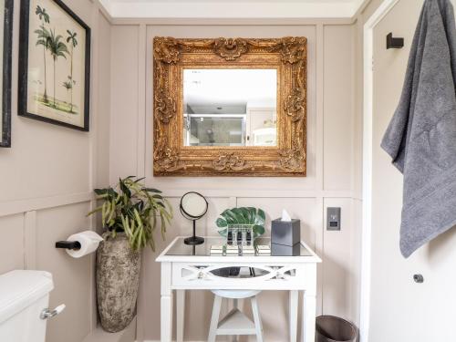 a bathroom with a mirror and a white sink at Inny Brook Cottage in Camelford