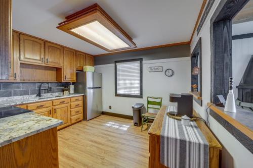 a large kitchen with wooden cabinets and a skylight at Private Boat Slip and Dock Lakefront Grove Retreat! in Grove