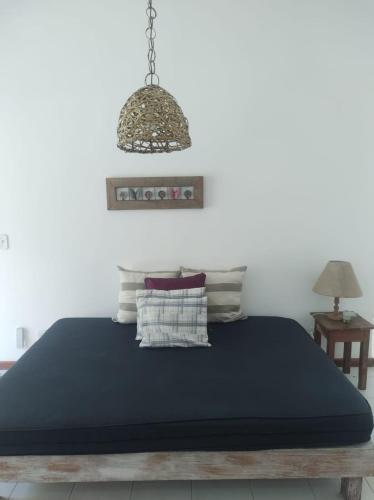 Katil atau katil-katil dalam bilik di Vila da Sol Itaipava casas e estúdios