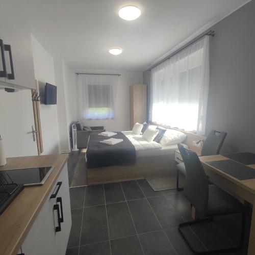 a hotel room with a bed and a kitchen with a kitchen at Horváth Apartman in Fertőd