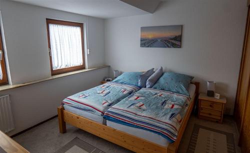 Postel nebo postele na pokoji v ubytování Ferienwohnung Schleiblick