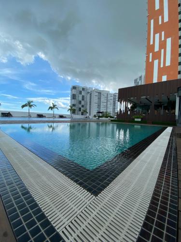 a large swimming pool in the middle of a city at SZ Home Legacy at Meritus in Perai