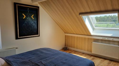 a bedroom with a large window and a bed at Boshovense Velden in Grobbendonk