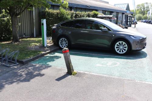 a green car parked in a parking lot at Bulli Beach House in Koksijde