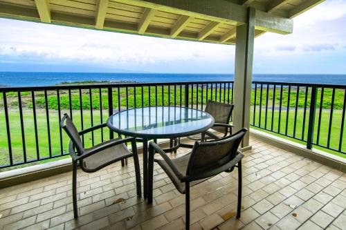 a table and chairs on a balcony with the ocean at Kapalua Villas Maui - Select Your Unit in Kahana