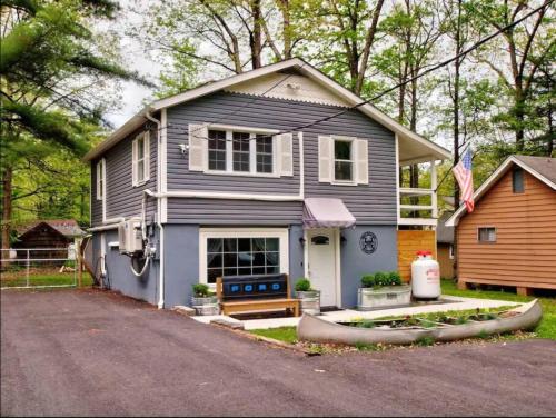a gray house with a driveway in front of it at Wally's Compound in Hawley