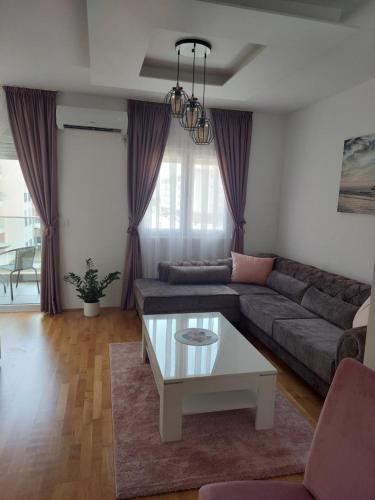 a living room with a couch and a coffee table at K2-SistersApartment in Podgorica