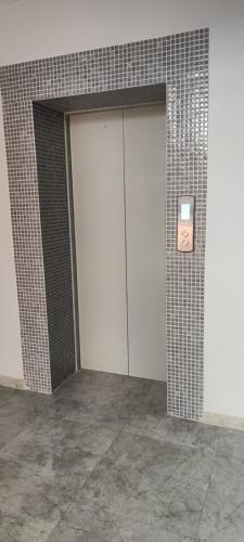 a door in a building with a sign on it at Уютная 2 ком.квартира in Kostanay