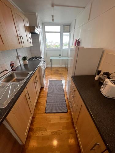 a kitchen with a sink and a counter at New Tower Bridge , Canada Water 2 bedroom flat with a view in London