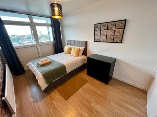 a bedroom with a bed and a large window at New Tower Bridge , Canada Water 2 bedroom flat with a view in London