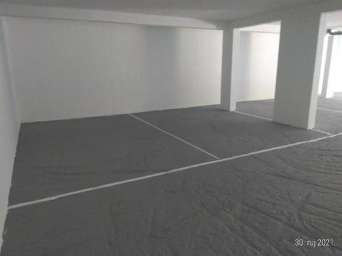 an empty room with white walls and a concrete floor at Nino Lux Apartments Ulcinj in Ulcinj