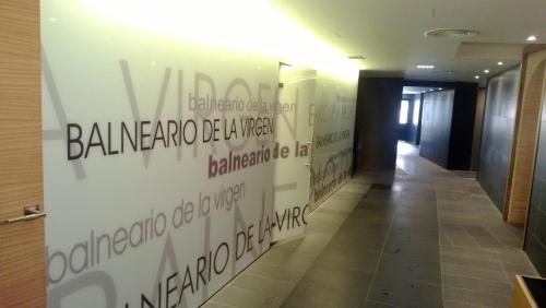 a hallway with writing on the wall in a building at Hotel Balneario de La Virgen in Jaraba