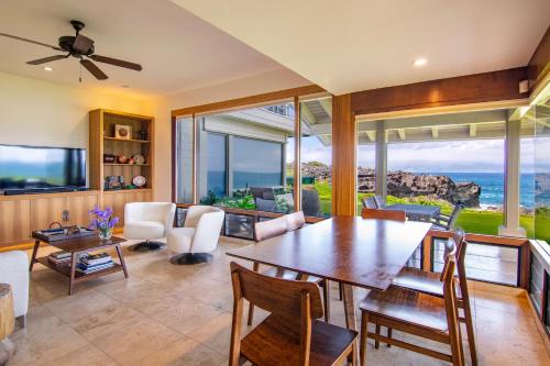 a dining room with a table and a view of the ocean at Kapalua Villas Maui - Select Your Unit in Kahana