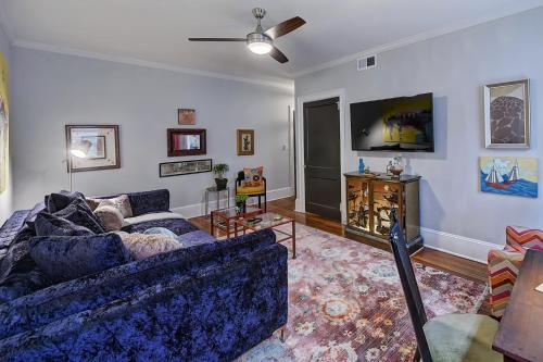 a living room with a blue couch and a tv at The Home Collection CLT: Lamar Avenue in Charlotte