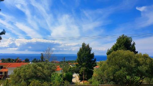 a view of the ocean from a town with trees at elgevacation villa 1 in Lagomandra