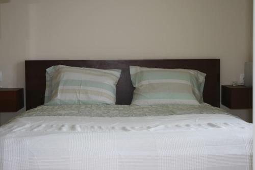 a large white bed with two pillows on it at elgevacation villa 1 in Lagomandra