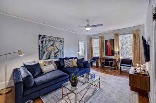a living room with a blue couch and a table at The Home Collection CLT: Lamar Avenue in Charlotte