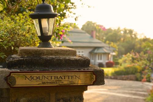 a street light with a sign on a wall at Mountbatten Bungalow- Thema Collection in Kandy