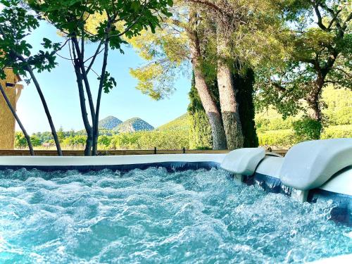 a water slide in the middle of a river at Entre vignes et horizon Appartement avec jacuzzi privatif et piscine commune chauffée in Sablet