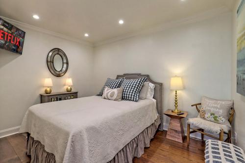 a bedroom with a bed and a chair and a mirror at King Bed Bungalow Just Feet from Historic Main Street in Blue Ridge
