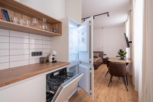 a small kitchen with a table and a dining room at Old town studio on Mucenieku street in Riga