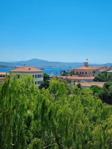 a view of a city with trees in the foreground at Hotel Delle Isole in La Maddalena