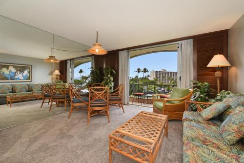 a living room with a couch and a table and chairs at Maui KaanapaliVilla A517 in Lahaina