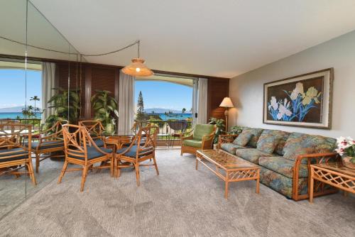 a living room with a couch and a table and chairs at Maui KaanapaliVilla A517 in Lahaina