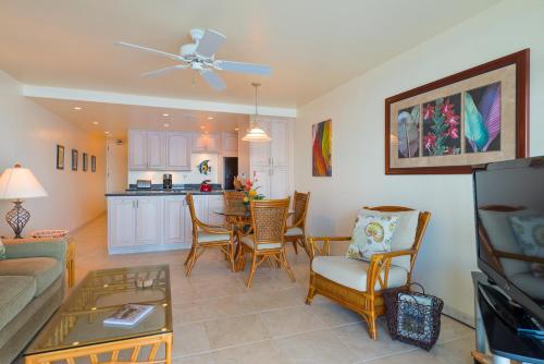 a living room with a couch and a table at Kahana Reef #402 in Kahana