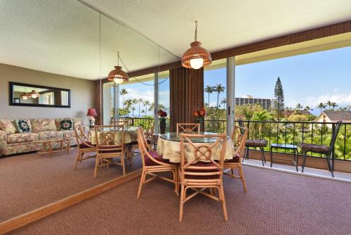 a dining room with a table and chairs on a balcony at Maui Kaanapali Villas #A317 in Lahaina