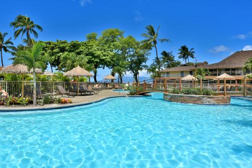 a swimming pool at a resort with palm trees at Maui Kaanapali Villas #A317 in Lahaina
