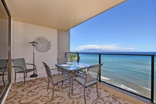 a dining room with a view of the ocean at Mahana Resort #518 in Kahana
