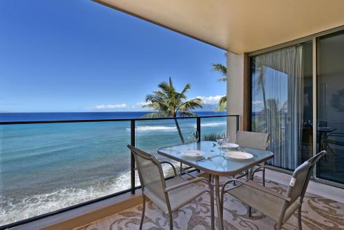 a dining room with a view of the ocean at Mahana Resort #518 in Kahana