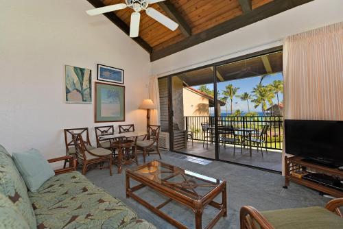 a living room with a couch and a table and chairs at Papakea Condo Unit D402 in Kahana