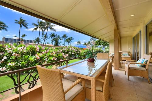 a balcony with a table and chairs and a view of the ocean at Maui Kaanapali Villas #D271 in Lahaina