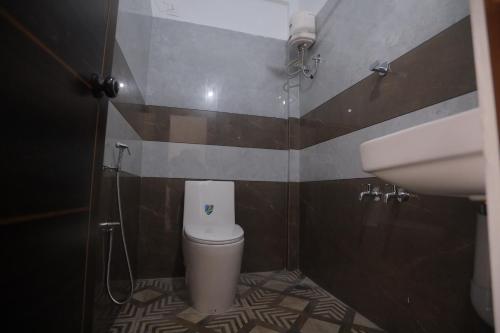 a bathroom with a toilet and a sink at New star homes in Kotamangalam