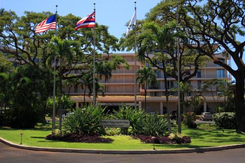two flags flying in front of a building at Maui Kaanapali Villas E290 in Lahaina