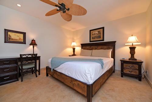 a bedroom with a bed and a ceiling fan at Kaanapali Plantation #52 Condo in Lahaina