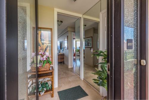 a hallway of a home with a mirror and plants at Mahana Resort #1017 in Kahana