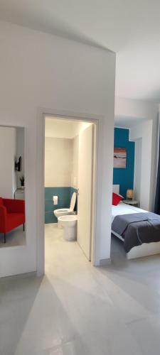 a bedroom with a bed and a bathroom at Manzoni 159 in Naples