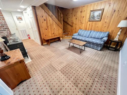 a living room with a blue couch and a table at Perfect Mountain Getaway in Stratton