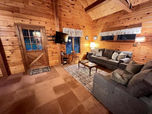 a living room with a couch and a tv in a cabin at Perfect Mountain Getaway in Stratton