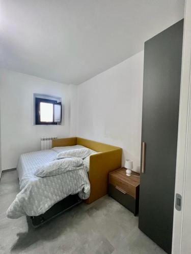 a bedroom with a bed and a television on the wall at Casa Dei Cavalieri in Cosenza