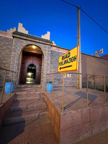 a sign in front of a building with ahad real mismatch at Riad Perlamazigh in Zagora