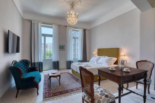 a bedroom with a bed and a table and chairs at Athenian Vintage Apartments in Athens
