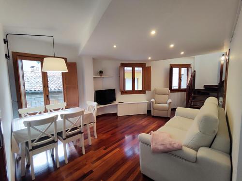 a living room with a table and a dining room at Can Manén in Camprodon