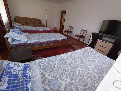 Postel nebo postele na pokoji v ubytování Meerim Guest House
