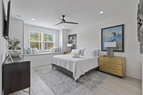 a white bedroom with a bed and a window at The White House Island,Beach,Hot Tub,Downtown in Saint Augustine